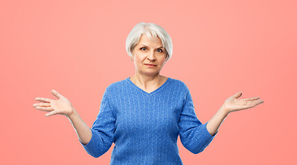 Image showing senior woman having no idea and shrugging