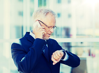 Image showing senior businessman calling on smartphone in city