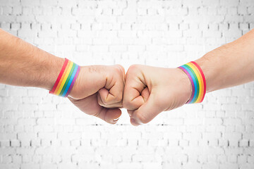 Image showing hands with gay pride wristbands make fist bump