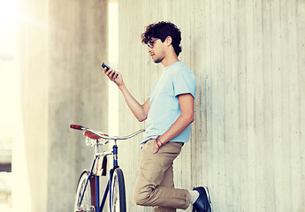 Image showing man with smartphone and fixed gear bike on street