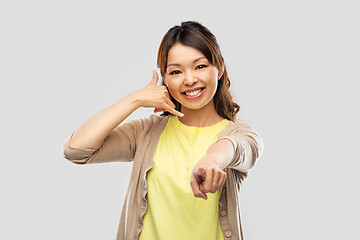 Image showing african asian making phone call gesture