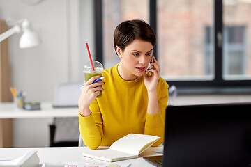 Image showing woman with drink calling on smartphone at office