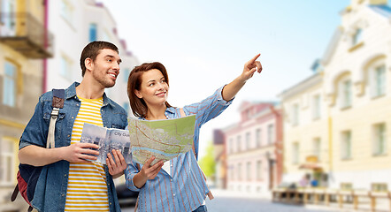 Image showing happy couple of tourists with city guide and map