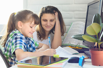 Image showing Girl and mom do a computer job at home