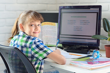 Image showing Girl 7-9 years old happy to work on the computer