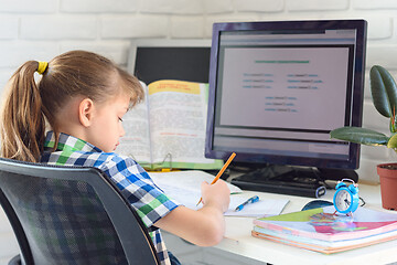 Image showing The child learns remotely on the computer