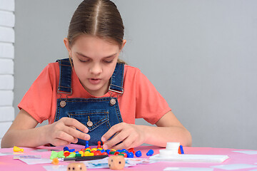 Image showing Girl enthusiastically plays board games