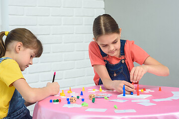 Image showing Two sisters play a board game