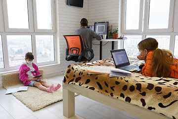 Image showing People do work on electronic devices in different places of the living room