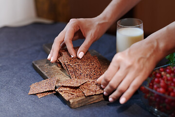 Image showing Vegan woman serving flaxseed bread