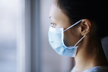 Image showing Woman staying at home and wearing protective surgical mask