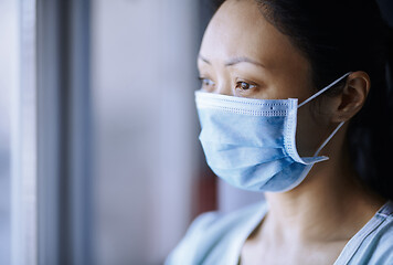 Image showing Woman staying at home wearing protective surgical mask