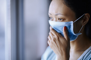 Image showing Woman staying at home wearing protective surgical mask