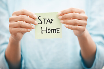 Image showing Woman holding adhesive note with Stay Home text