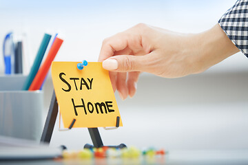 Image showing Human hand holding adhesive note with Stay Home order