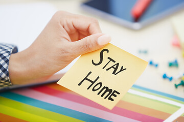 Image showing Human hand holding adhesive note with Stay Home text