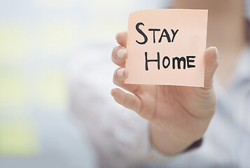 Image showing Hands holding sticky note with Stay Home text