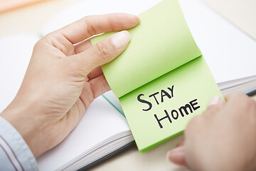 Image showing Hands holding sticky note with Stay Home text