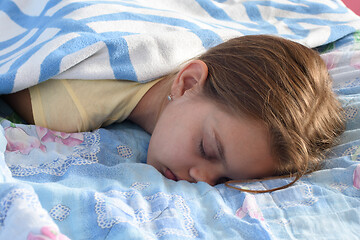 Image showing Tired girl fell asleep in the afternoon on the bed