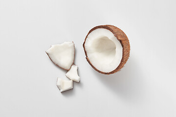 Image showing Top view of fresh natural organic coconut\'s half on a light grey background.