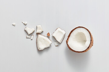 Image showing Top view of fresh ripe natural organic tropical coconut fruit on a light grey background