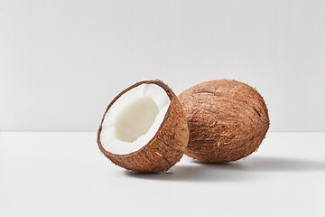 Image showing Fresh ripe organic coconut fruits on a gray duotone background.