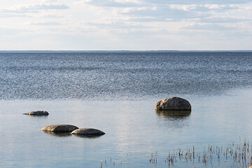 Image showing Coastal view with rocks in calm water