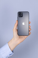 Image showing Hand holding new iPhone 11 Pro on gray background