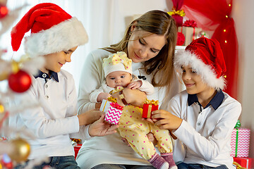 Image showing happy family in Christmas attire with gifts