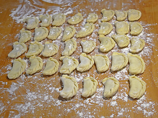 Image showing Dumplings on the yellow kitchen board