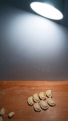 Image showing Uncooked dumplings on the kitchen board lighting the lamp lanter