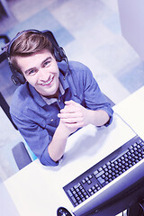 Image showing male call centre operator doing his job top view