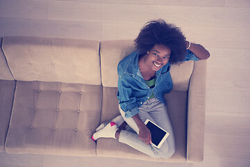 Image showing african american woman at home with digital tablet top view