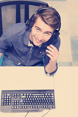 Image showing male call centre operator doing his job top view