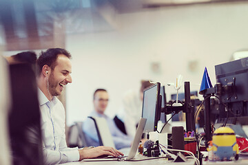 Image showing businessman working using a laptop in startup office