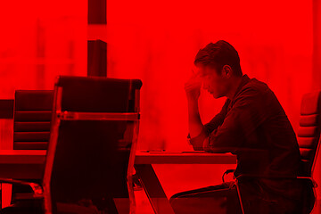 Image showing young businessman relaxing at the desk