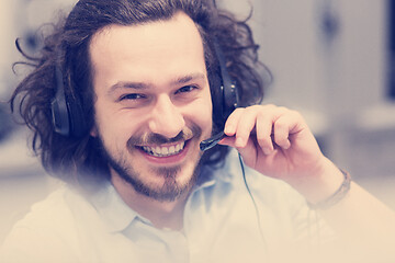 Image showing male call centre operator doing his job