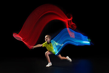 Image showing one caucasian young teenager girl woman playing Badminton player on black background