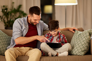 Image showing father and son with tablet pc playing at home