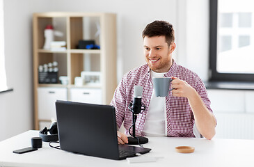 Image showing blogger with laptop and microphone audio blogging