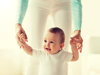 Image showing happy baby learning to walk with mother help