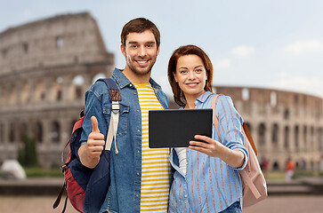 Image showing happy couple of tourists with tablet computer