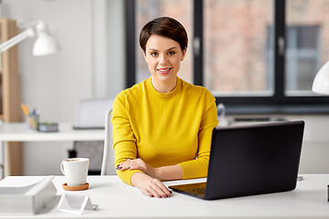 Image showing businesswoman with laptop computer at office