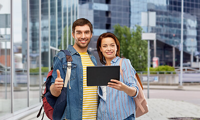 Image showing couple of tourists with tablet computer in city