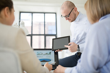 Image showing close up of business team with tablet pc at office