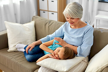 Image showing grandmother and granddaughter resting on pillow