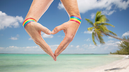 Image showing male hands with gay pride wristbands showing heart