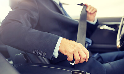 Image showing senior businessman fastening car seat belt