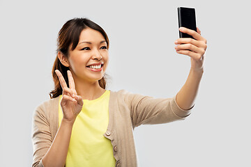 Image showing asian woman taking selfie by smartphone