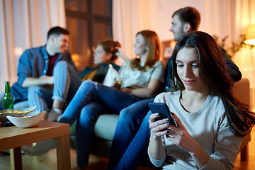 Image showing young woman with smartphone at home party